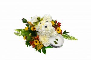 A delightful pooch made out of carnations and other seasonal flowers with a keepsake ceramic dog bowl