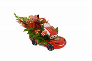 Speed your way into someone’s heart with this winning flower arrangement inside the Cars Lightning McQueen Cookie Jar.